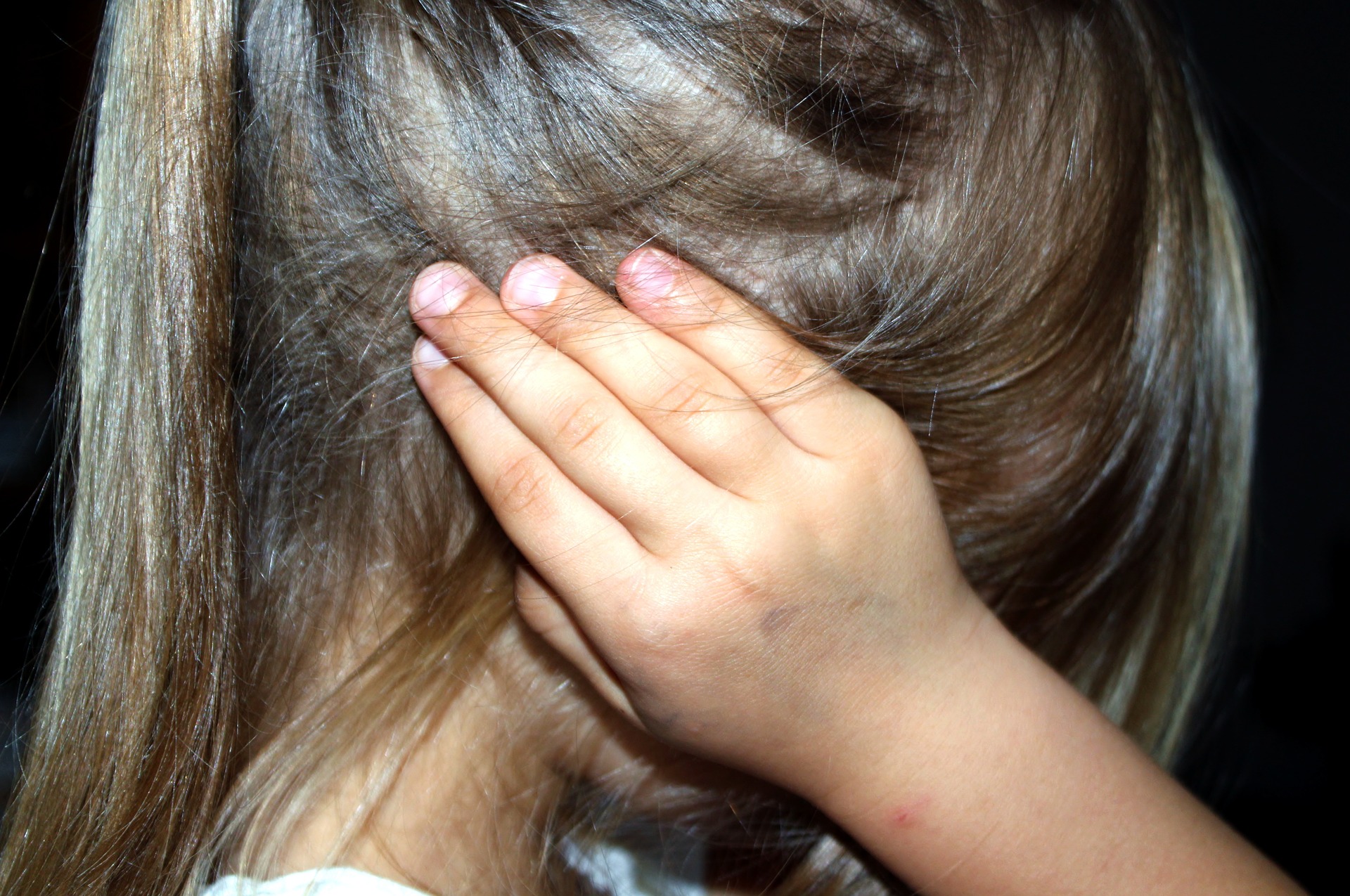 Young Child Covering Her Ears