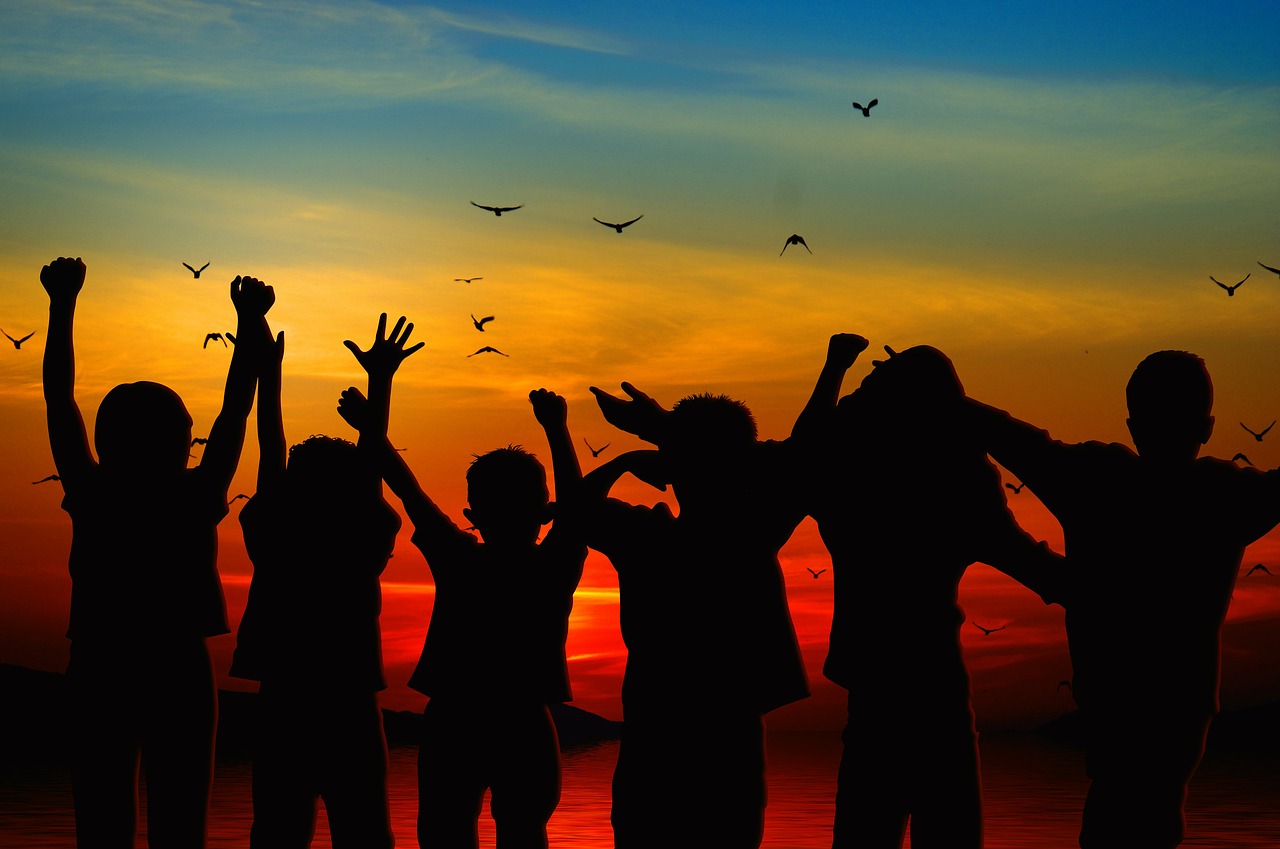 Group of People Jumping during a Sunset