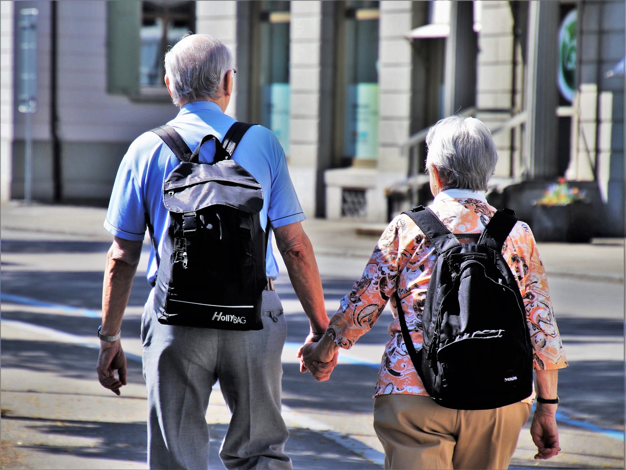 Older Couple Wearing Backpacks